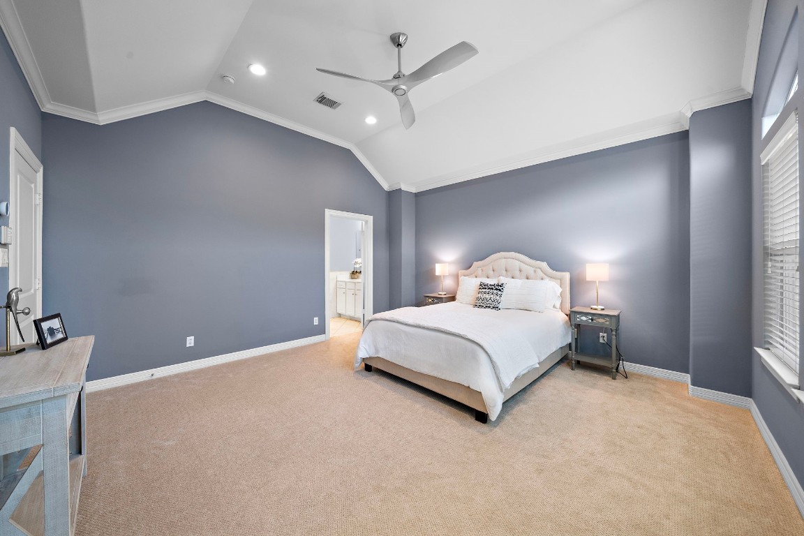 3929 Floyd Street Houston, TX 77007 - Photo 3 of 42 a bedroom with a large bed and a chandelier