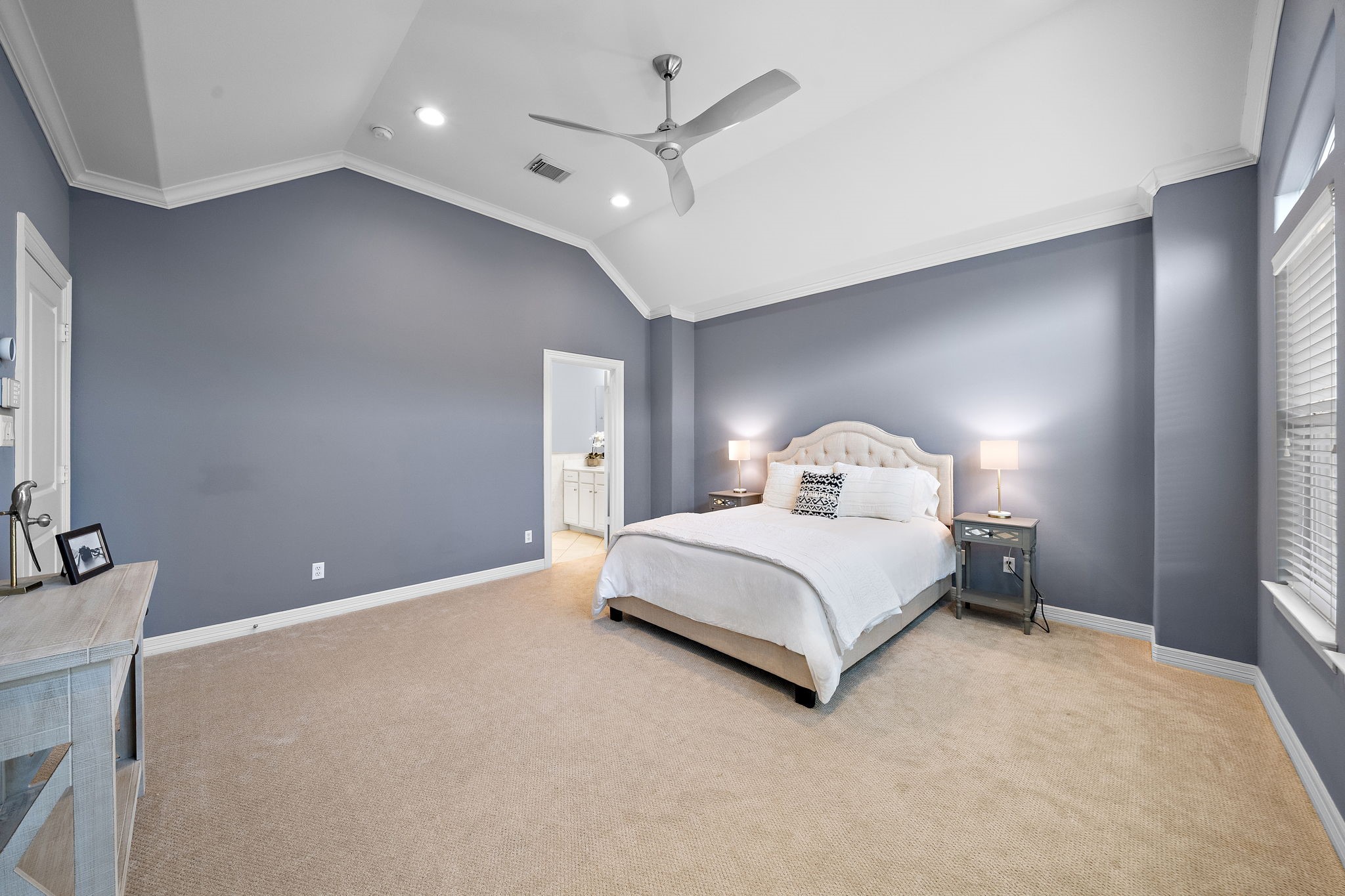 3929 Floyd Street Houston, TX 77007 - Photo 3 of 42 a bedroom with a large bed and a chandelier