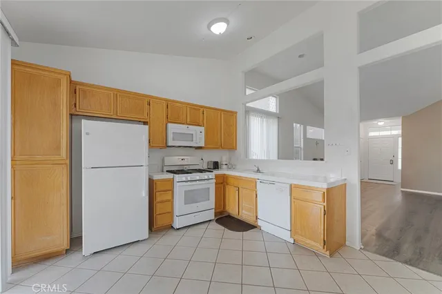 a kitchen with stainless steel appliances a refrigerator sink and microwave