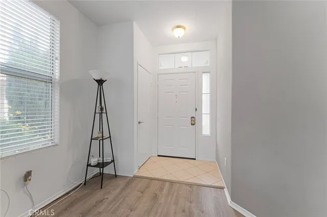 a view of a room with wooden floor and a window