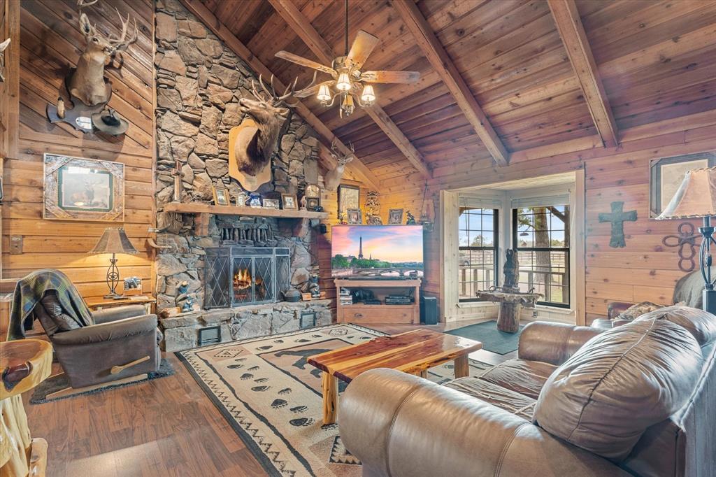 a bedroom with a bed a couch and dresser next to a window