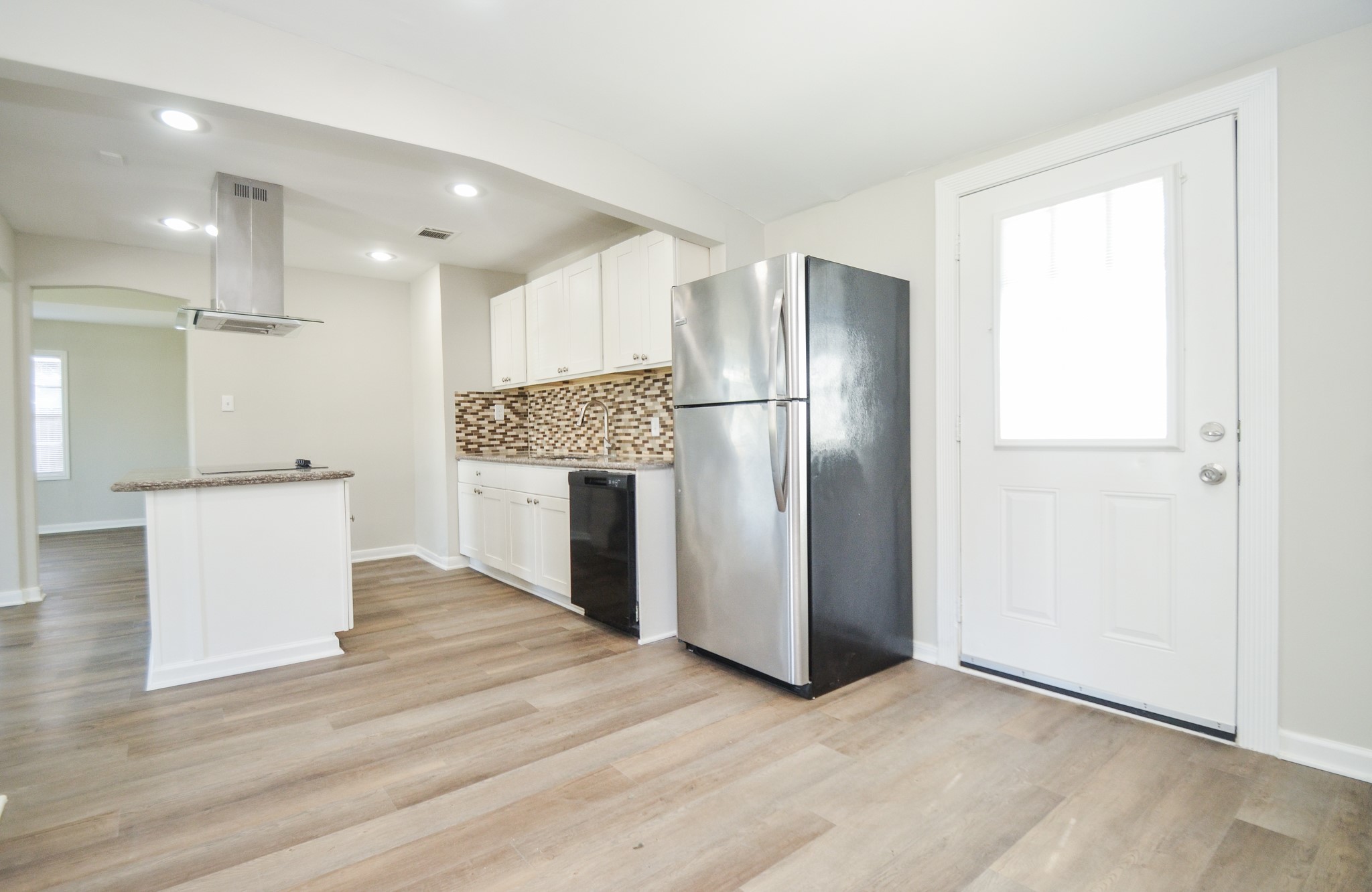 5238 Keystone Street Houston, TX 77021 - Photo 15 of 31 Kitchen includes a refrigerator and a mosaic-style backsplash.