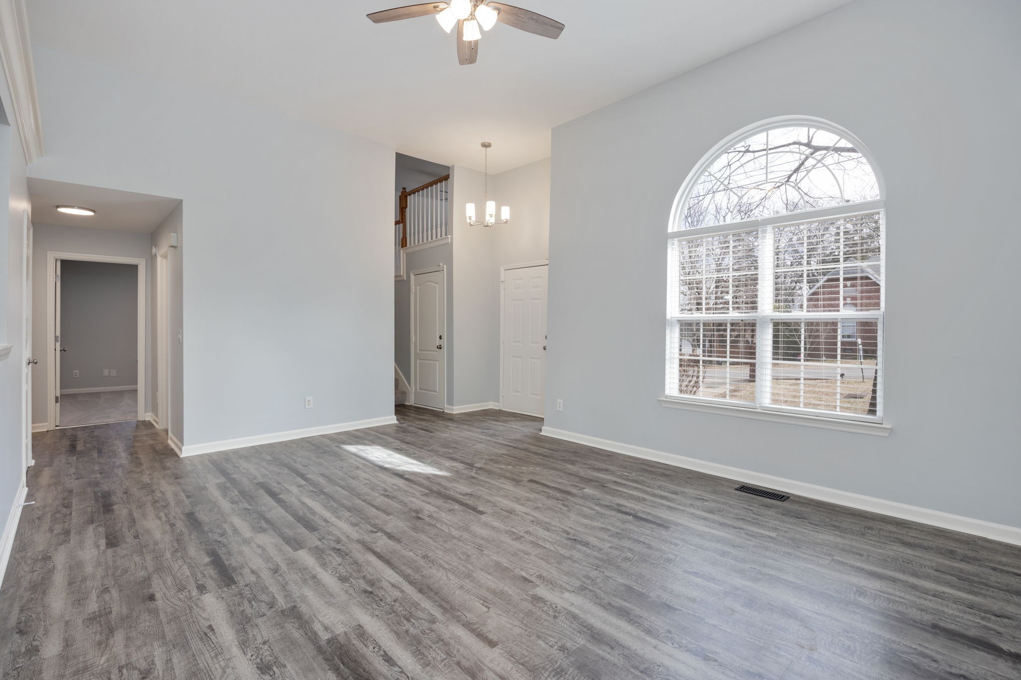 3044 Stone Bridge Road Antioch, TN 37013 - Photo 7 of 47 an empty room with wooden floor chandelier and windows