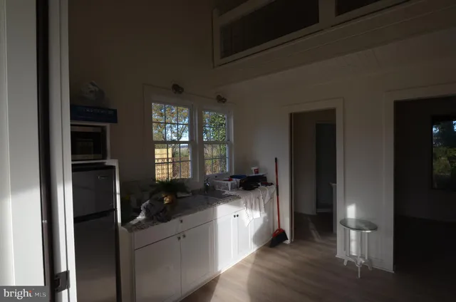 a kitchen with granite countertop a refrigerator and a sink