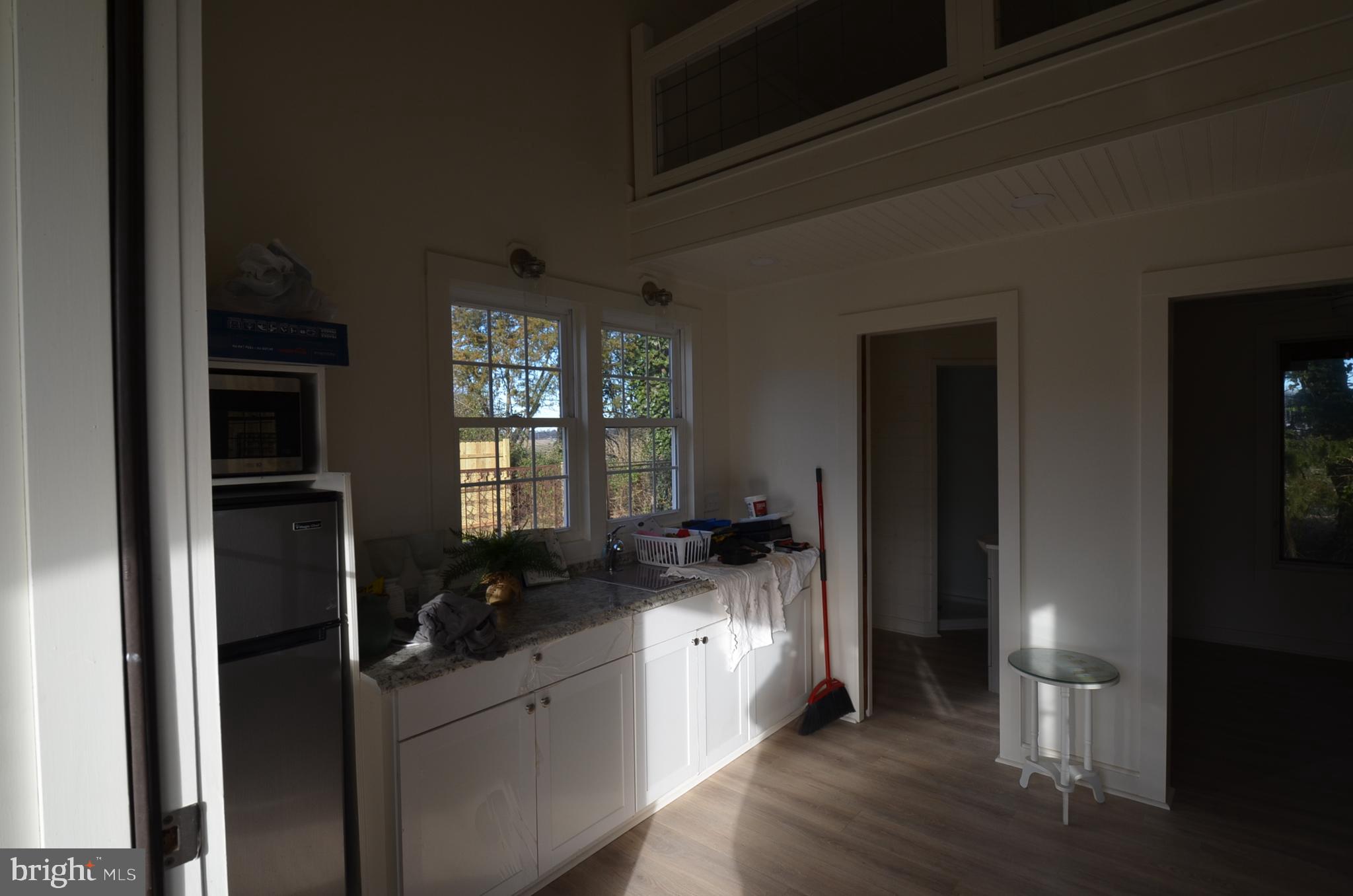 24697 Broadkill Road Milton, DE 19968 - Photo 3 of 10 a kitchen with granite countertop a refrigerator and a sink