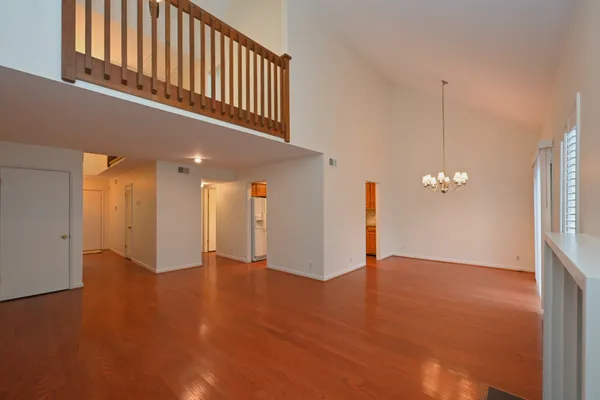 a view of an empty room with a ceiling fan and window
