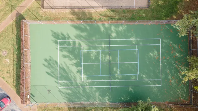 an empty room with a ceiling fan and a window