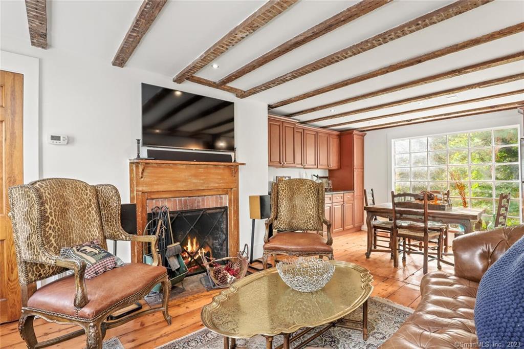 49 Hollow Tree Ridge Road Darien, CT 06820 - Photo 1 of 25 #49 - Main Level LR with Fireplace, dining area and Kitchen