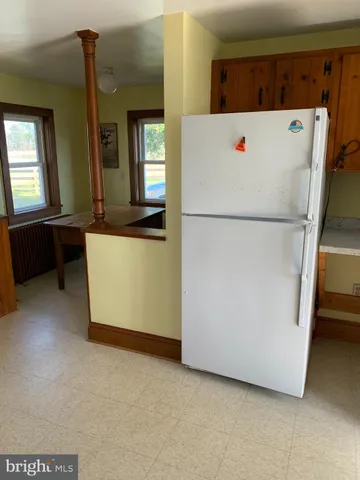 a white refrigerator freezer sitting in a kitchen