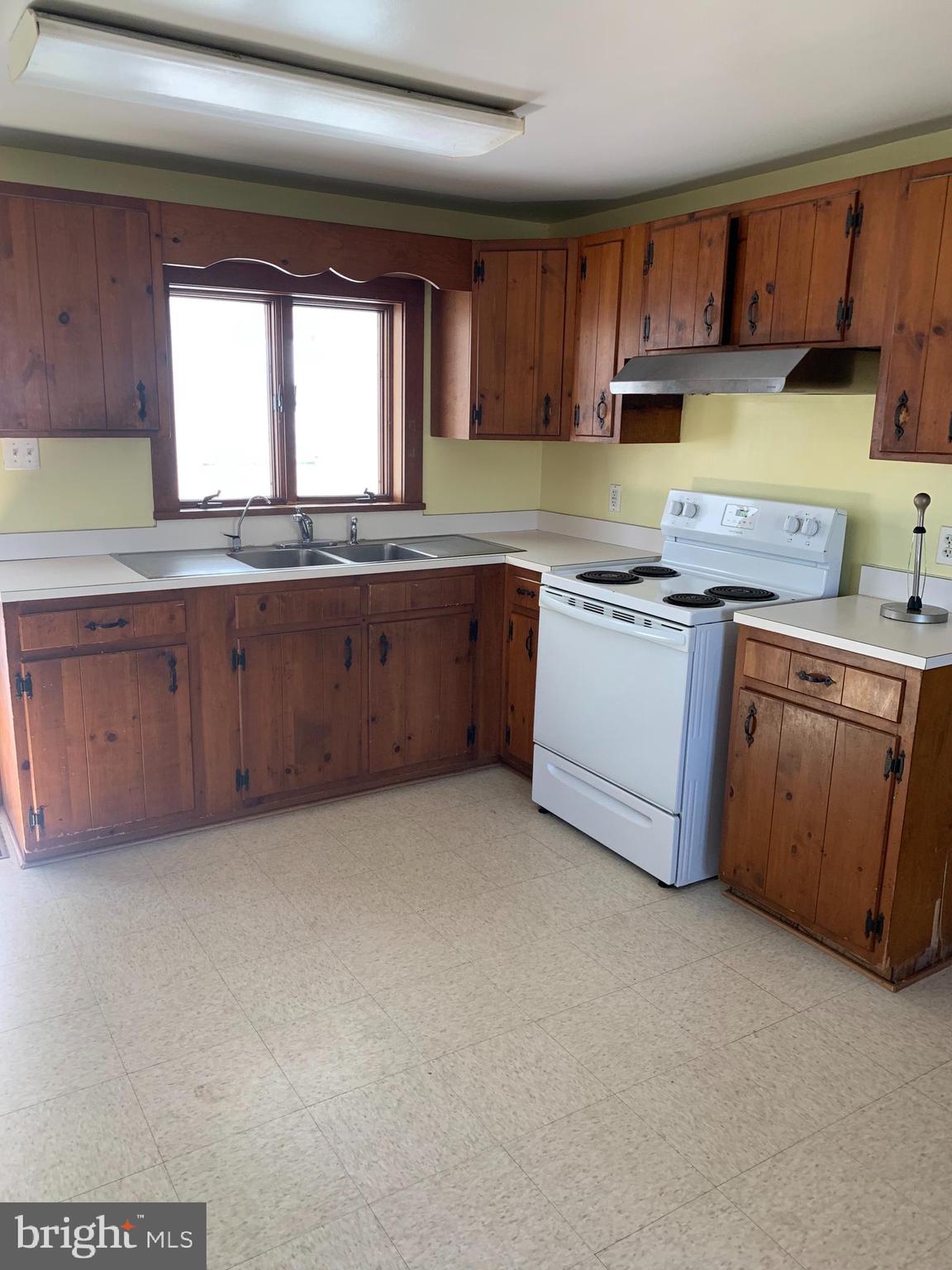 23260 Wells Point Lane Bozman, MD 21612 - Photo 10 of 18 a kitchen with stainless steel appliances granite countertop a stove a sink and a microwave