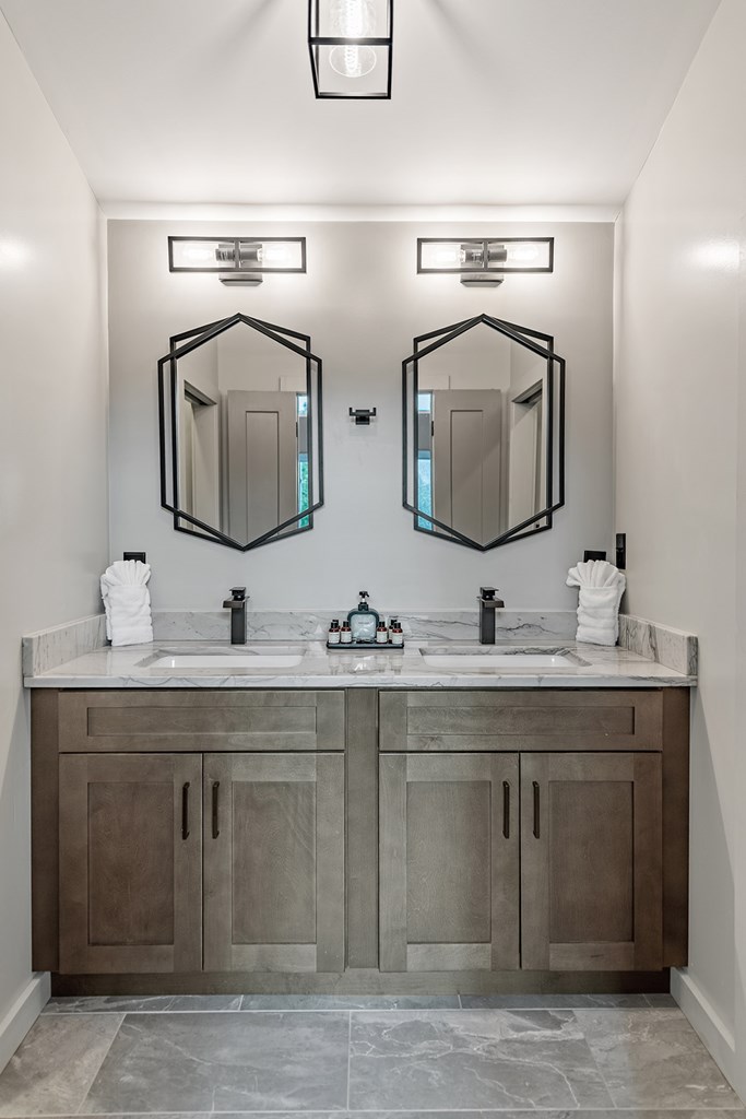 880 Little Bushy Head Road Blue Ridge, GA 30513 - Photo 22 of 51 a bathroom with double sink and two mirror