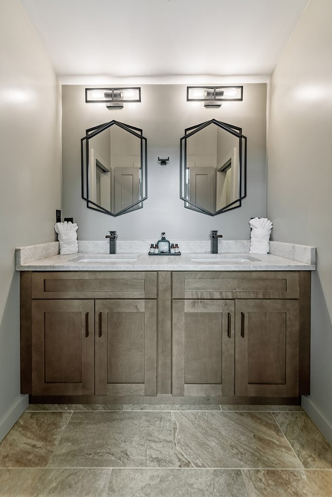 880 Little Bushy Head Road Blue Ridge, GA 30513 - Photo 28 of 51 a bathroom with a double vanity sink and mirror