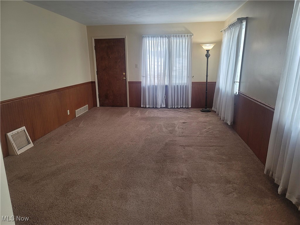 4145 Manchester Road Akron, OH 44319 - Photo 17 of 28 Unfurnished room featuring wood walls, carpet flooring, and a wainscoted wall