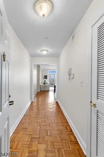 a view of a hallway view with wooden floor and staircase