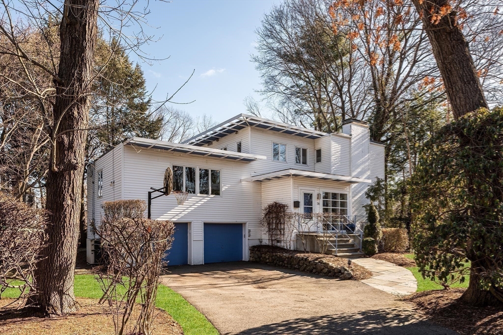 56 Varick Road Newton, MA 02468 - Photo 1 of 21 a front view of a house with garden