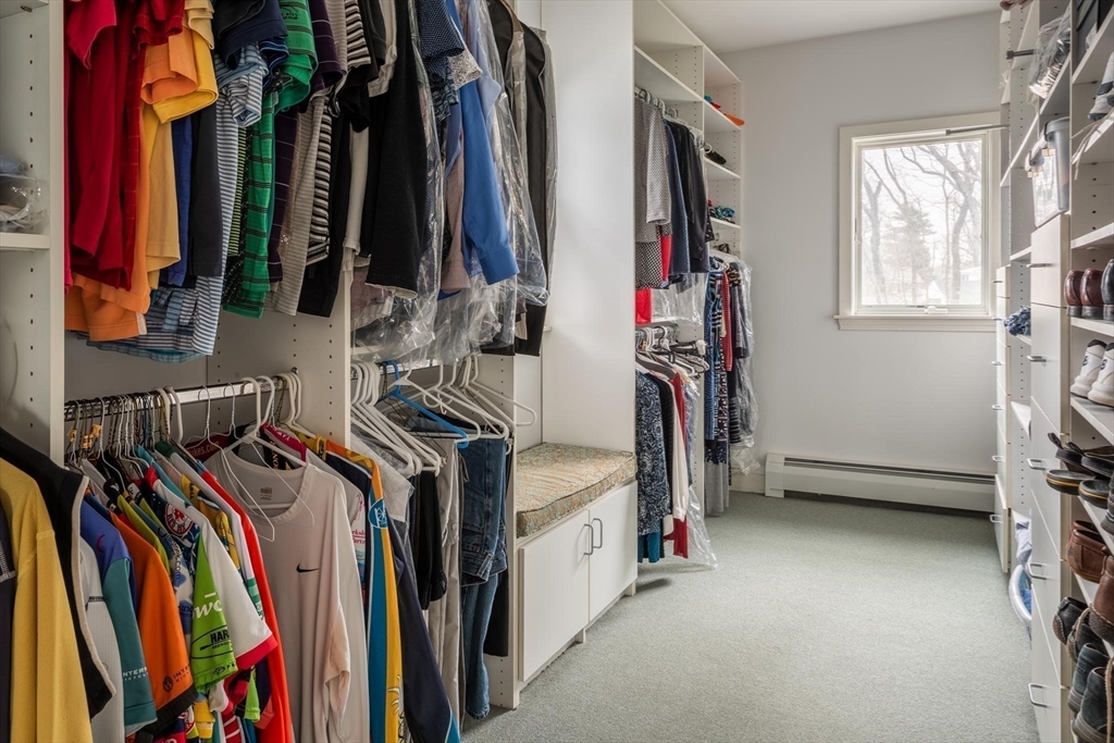 56 Varick Road Newton, MA 02468 - Photo 13 of 21 a view of walk in closet with clothes and shoes