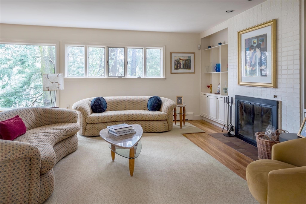 56 Varick Road Newton, MA 02468 - Photo 2 of 21 a living room with furniture a fireplace and a large window