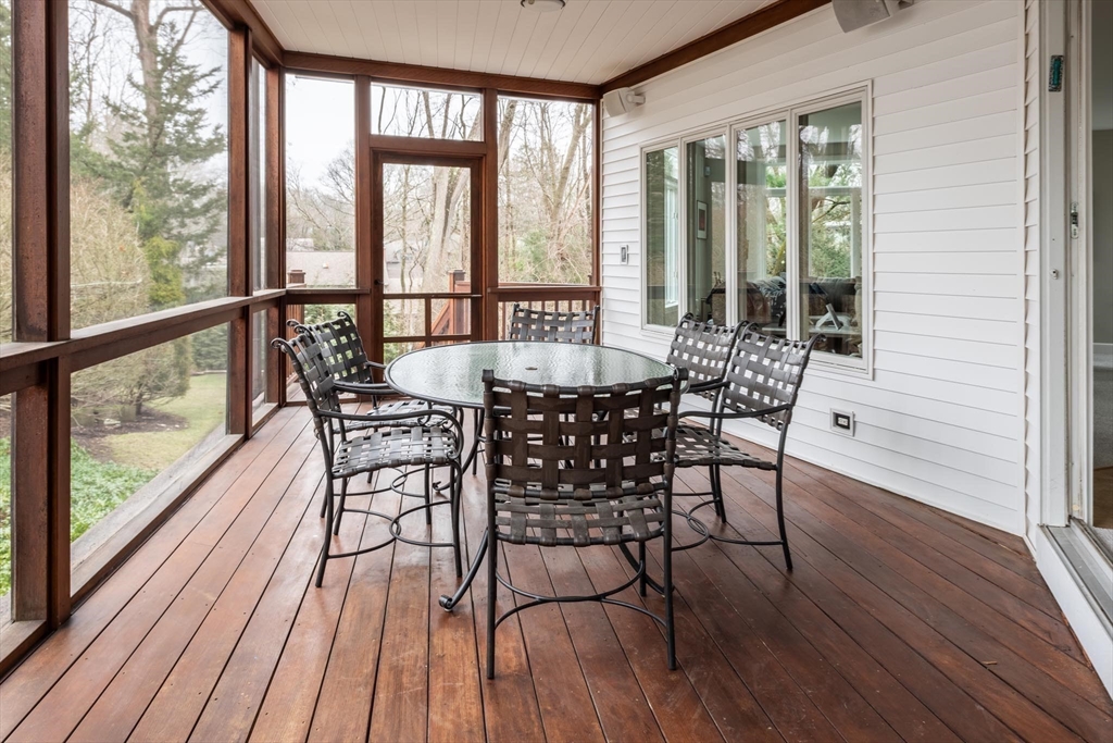 56 Varick Road Newton, MA 02468 - Photo 8 of 21 a dining room with wooden floor glass walls and glass windows