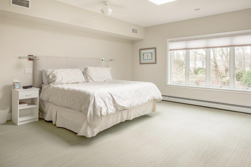 56 Varick Road Newton, MA 02468 - Photo 10 of 21 a bedroom with a bed and a large window