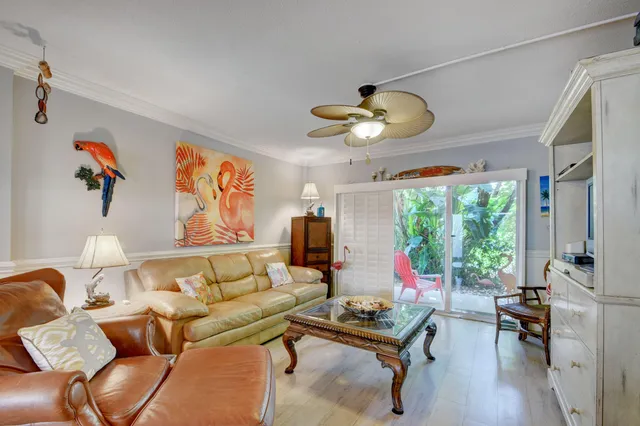 a living room with furniture a flat screen tv and a large window