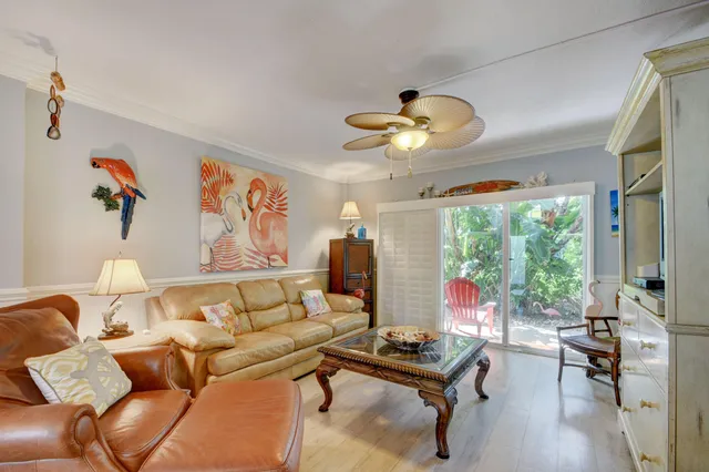 a living room with furniture chandelier and a flat screen tv