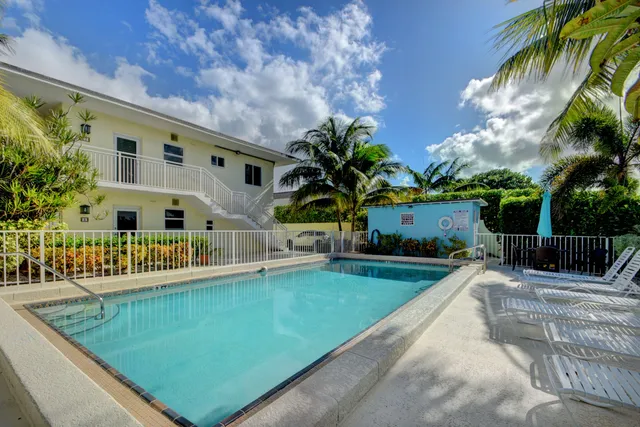 a view of swimming pool with outdoor seating and plants
