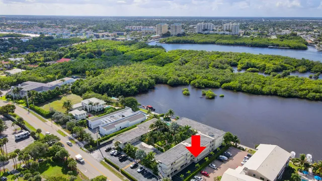 a roof deck with table and chairs and potted plants