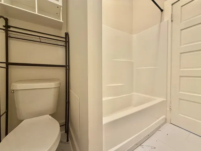 a white toilet sitting next to a bathroom sink