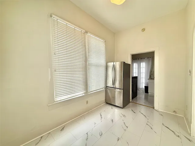 a view of kitchen and refrigerator