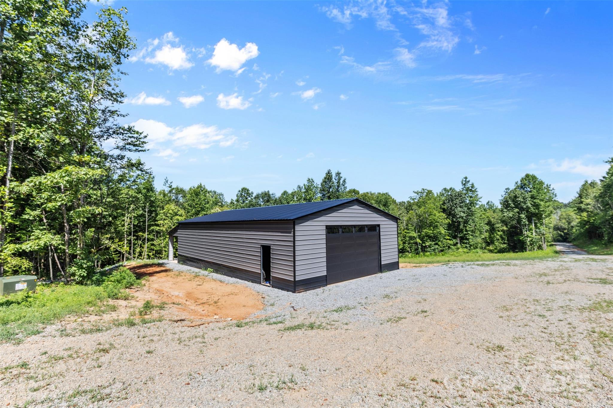 1371 Alexis High Shoals Road Dallas, NC 28034 - Photo 2 of 19 a view of a wooden fence with a house in the background