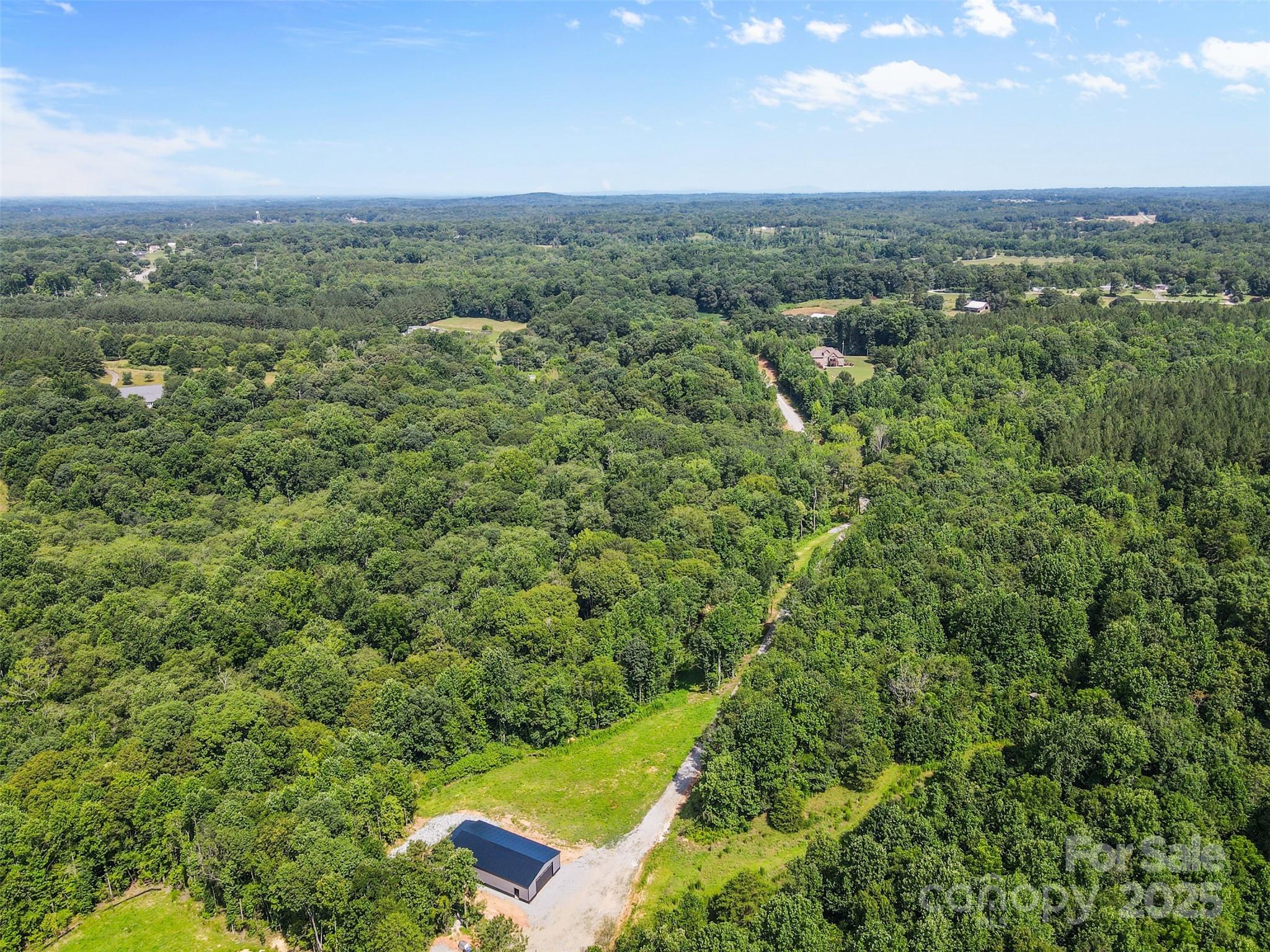 1371 Alexis High Shoals Road Dallas, NC 28034 - Photo 8 of 19 a view of a city with lush green forest