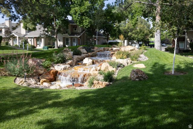 6936 South 775 East, Unit B Midvale, UT 84047 - Photo 2 of 33 View of green lawn featuring a garden pond
