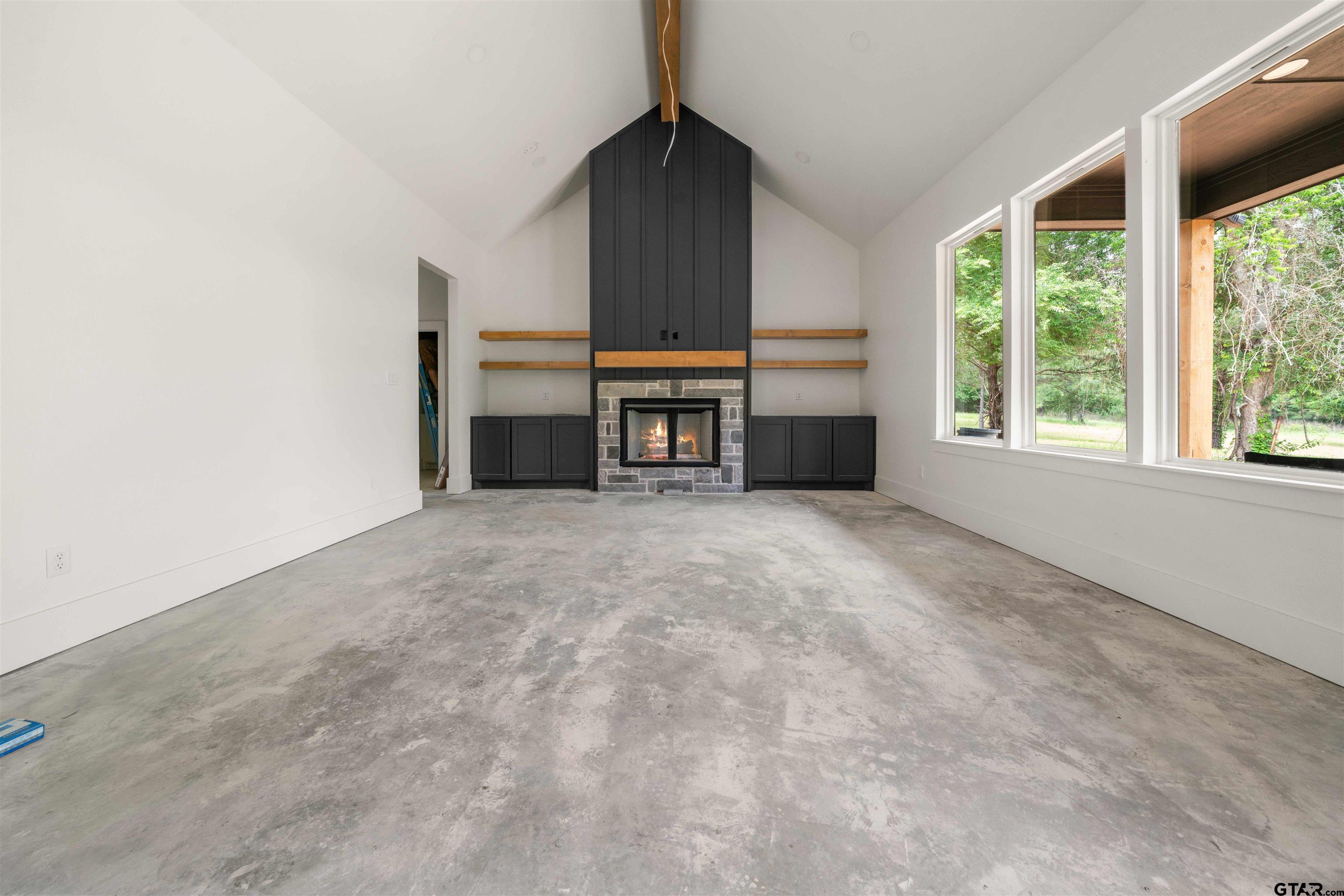 15050 7 League Road Tyler, TX 75703 - Photo 13 of 35 an empty room with windows and fireplace
