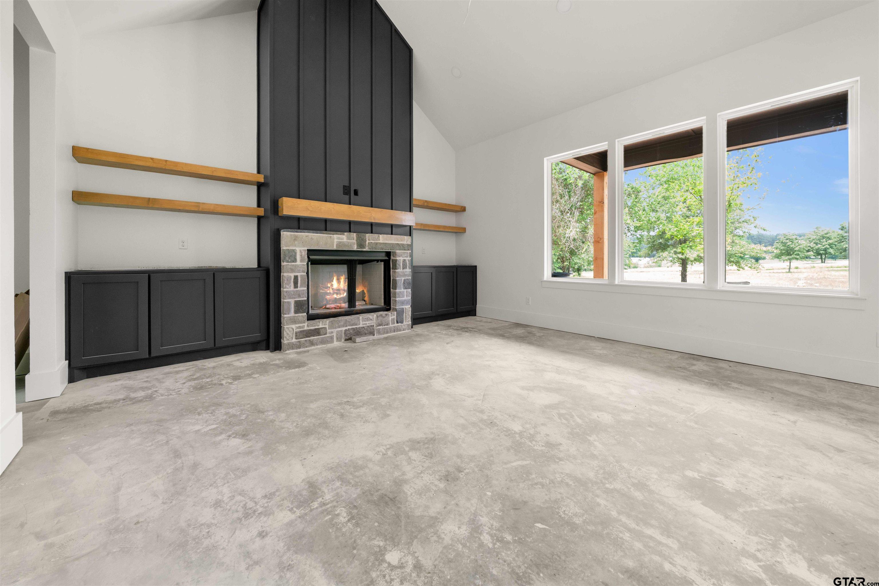 15050 7 League Road Tyler, TX 75703 - Photo 14 of 35 an empty room with windows and fireplace