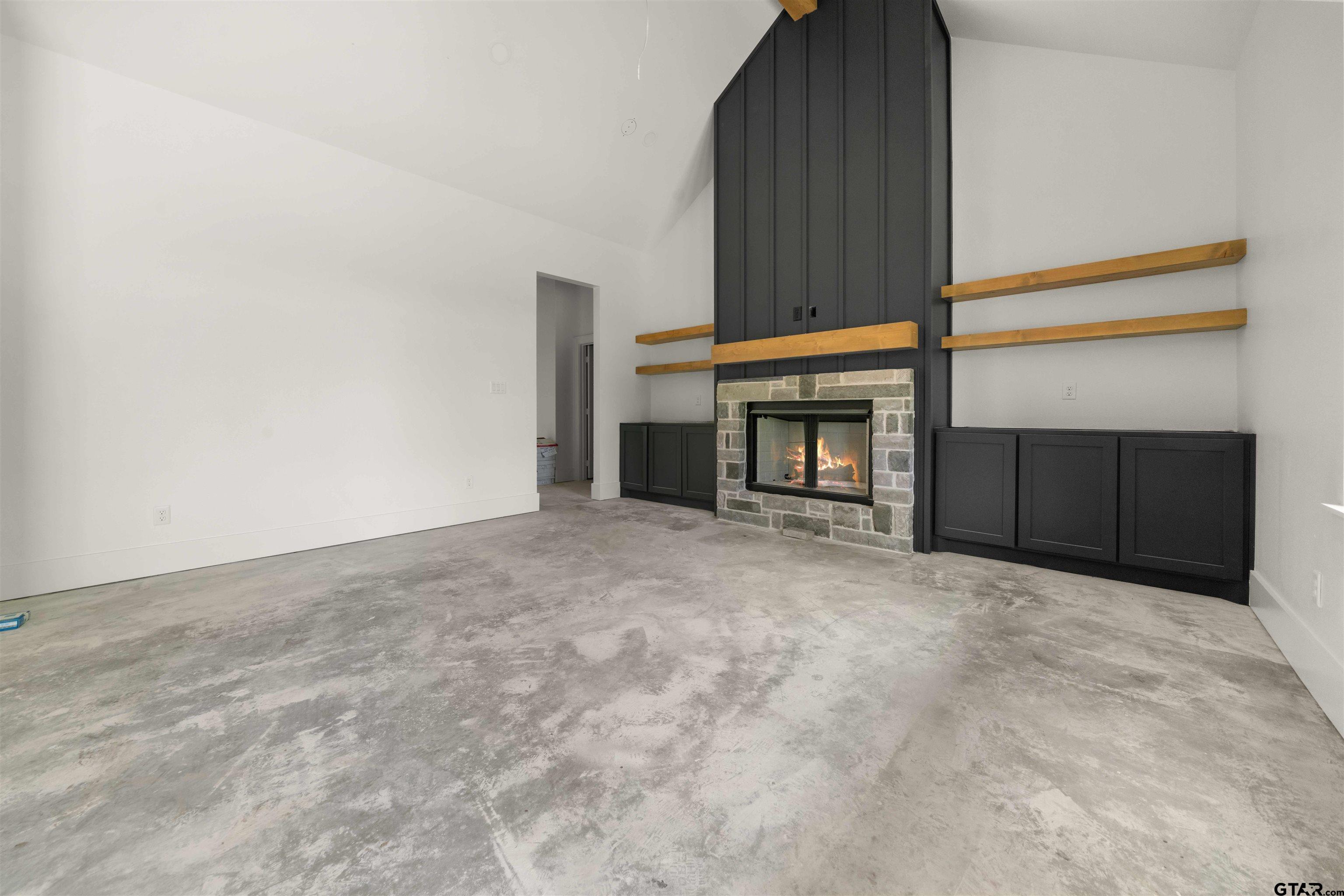 15050 7 League Road Tyler, TX 75703 - Photo 15 of 35 a view of an empty room with fireplace and a window