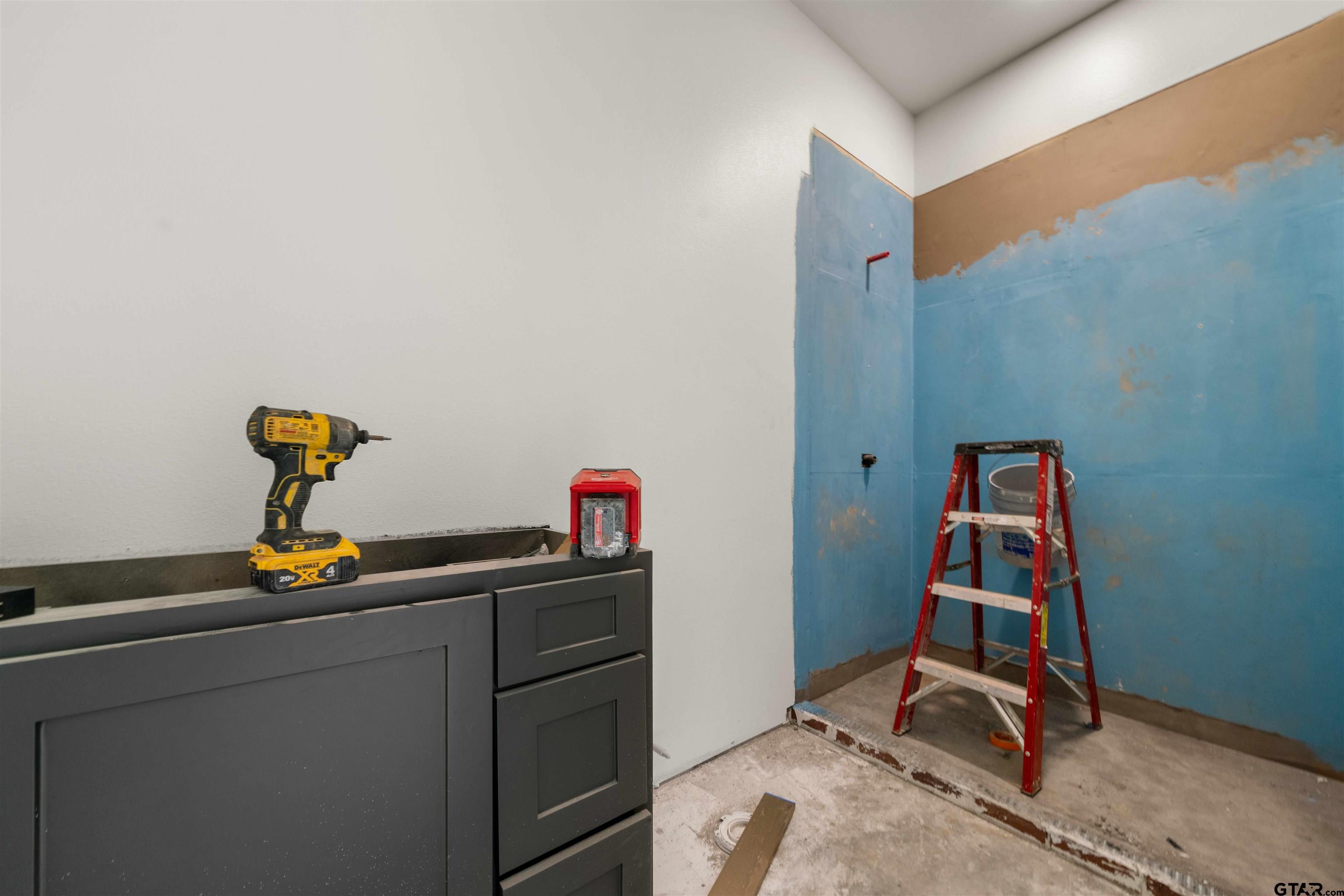 15050 7 League Road Tyler, TX 75703 - Photo 28 of 35 a room with gym equipment and wooden floor