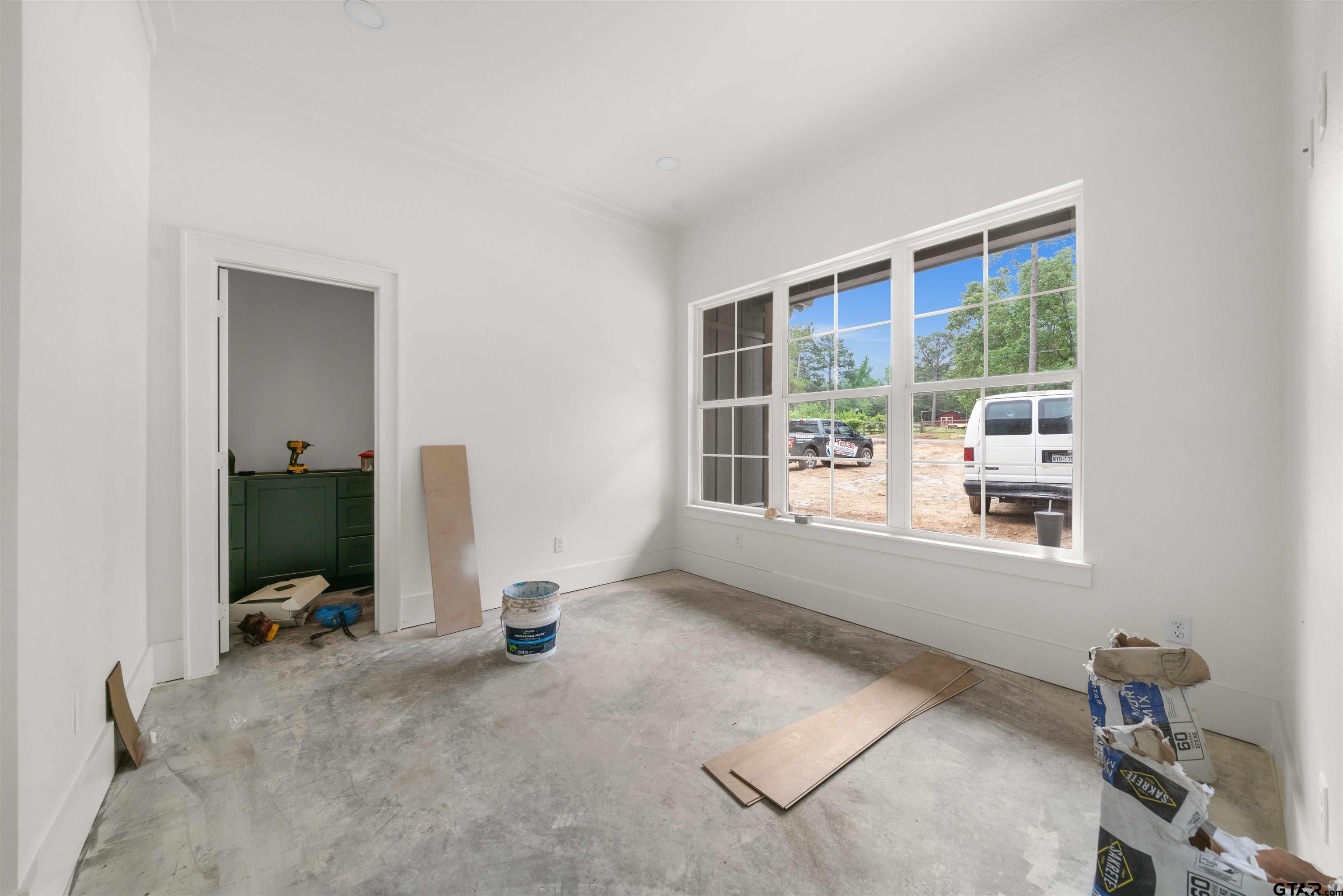 15050 7 League Road Tyler, TX 75703 - Photo 6 of 35 a view of a room with gym equipment and windows