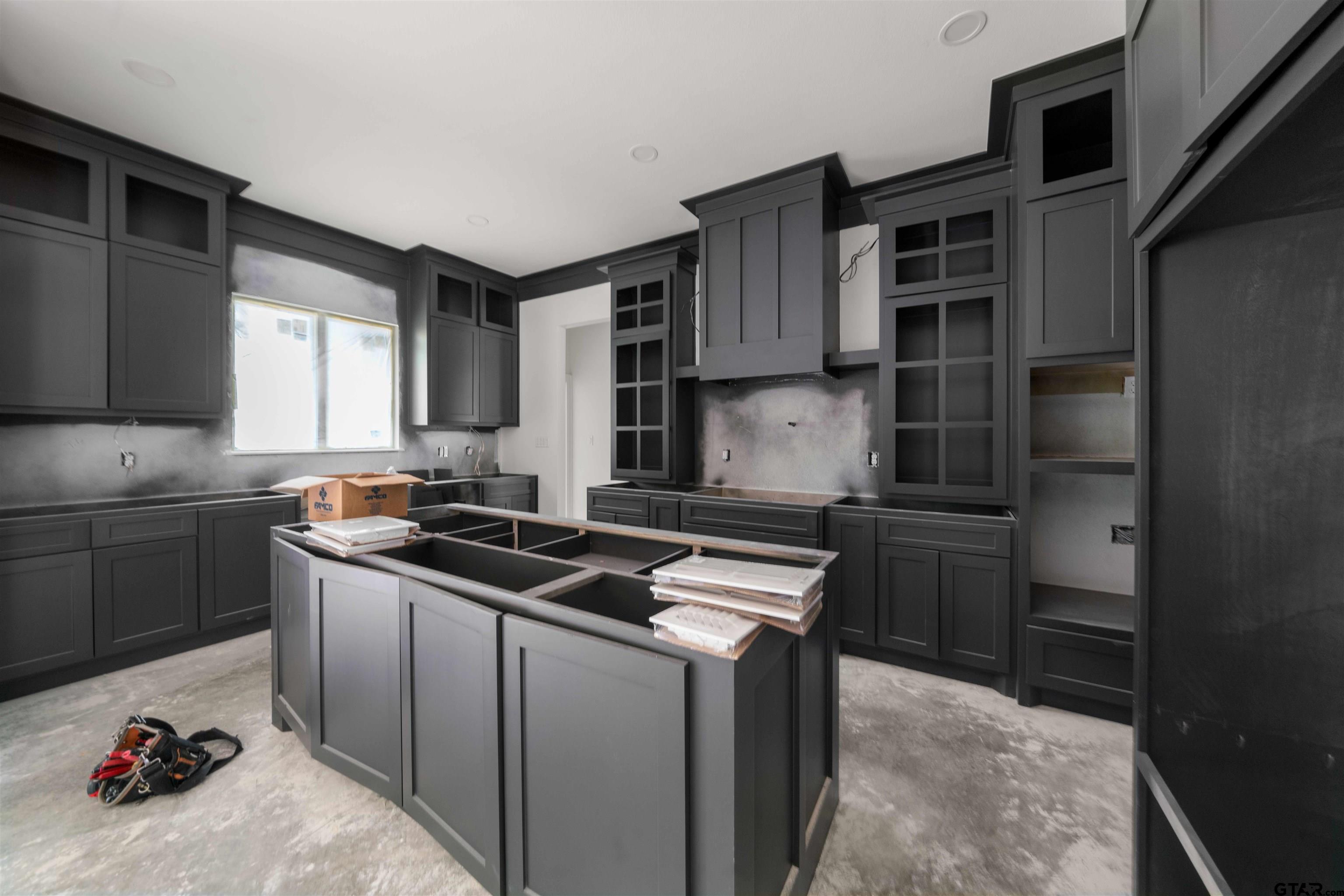 15050 7 League Road Tyler, TX 75703 - Photo 7 of 35 a kitchen with stainless steel appliances a sink stove and cabinets