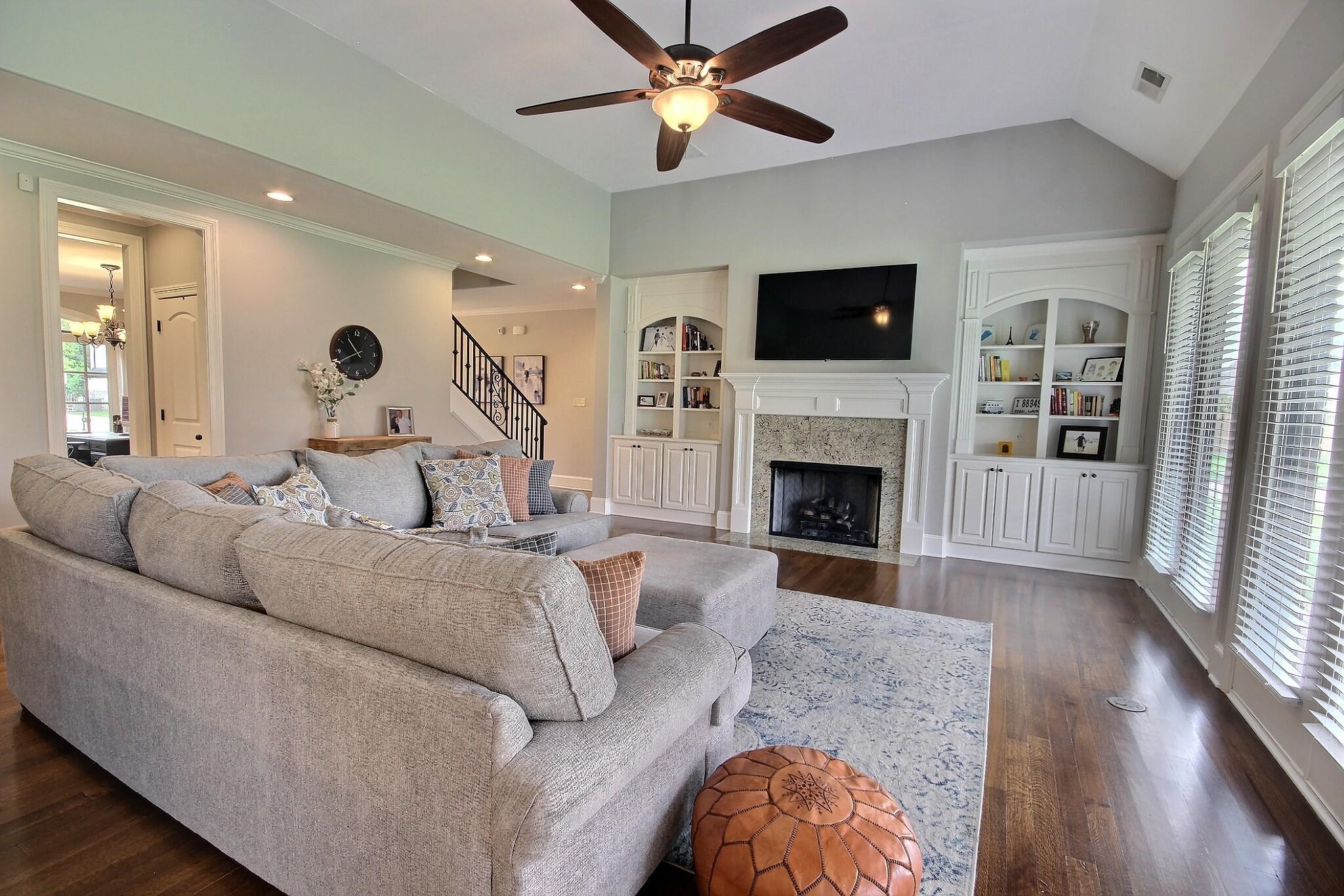 1707 Totty Lane Collierville, TN 38017 - Photo 12 of 40 a living room with furniture a flat screen tv and a fireplace