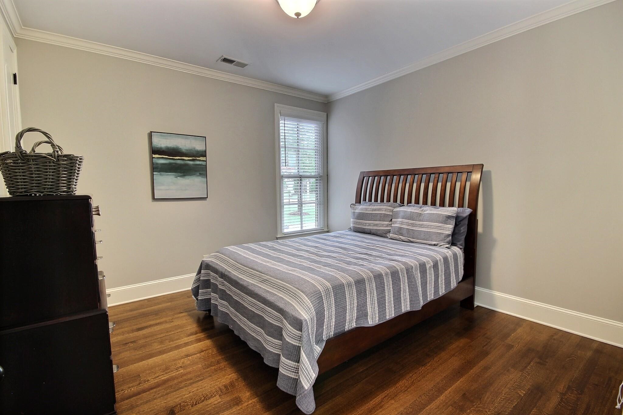1707 Totty Lane Collierville, TN 38017 - Photo 19 of 40 a bedroom with a bed and wooden floor