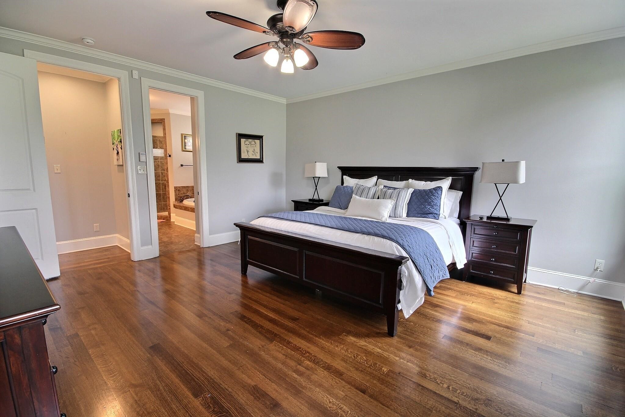 1707 Totty Lane Collierville, TN 38017 - Photo 8 of 40 a bedroom with a bed lamp closet and wooden floor