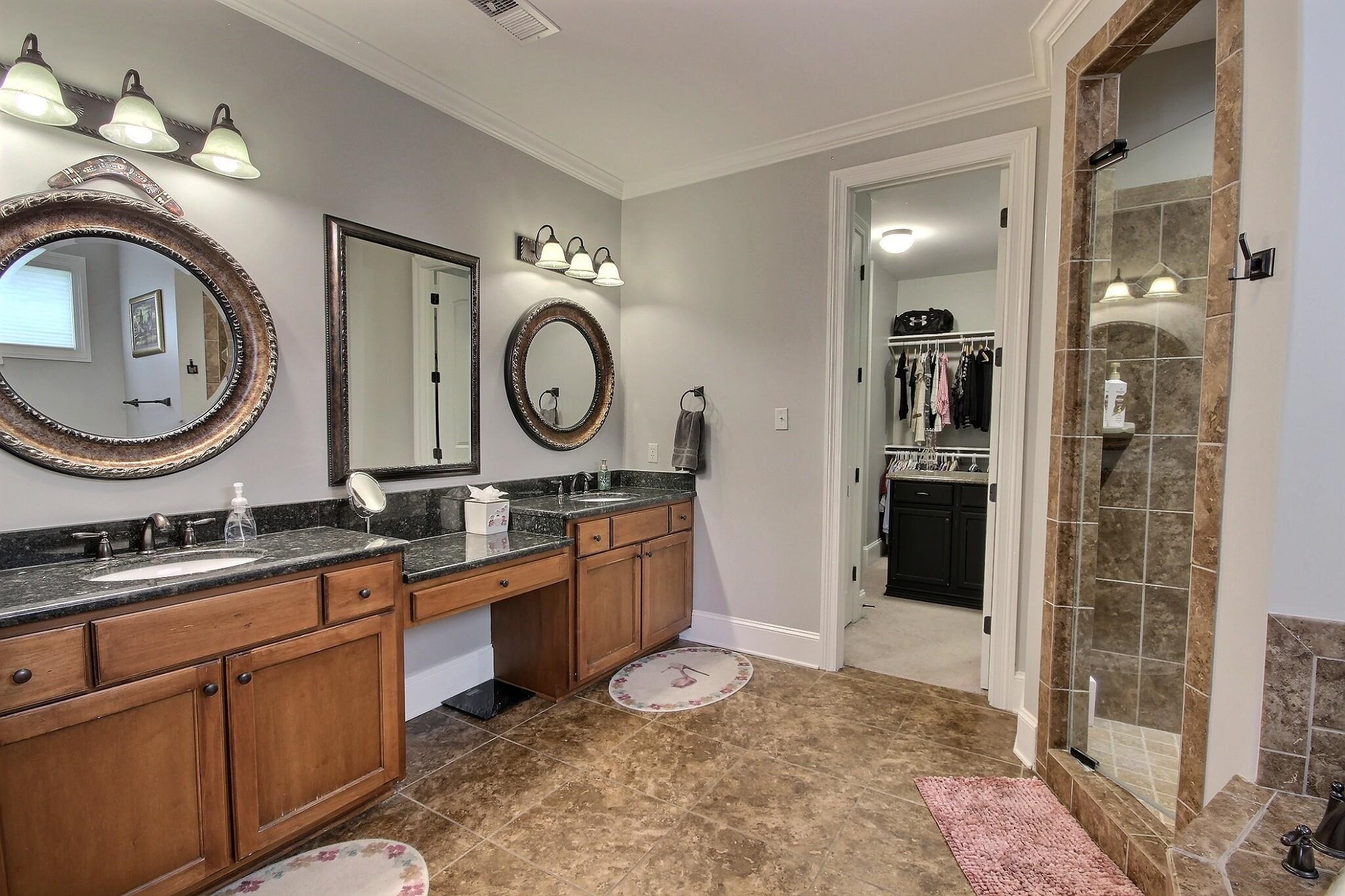 1707 Totty Lane Collierville, TN 38017 - Photo 10 of 40 a bathroom with a granite countertop sink a mirror and a shower