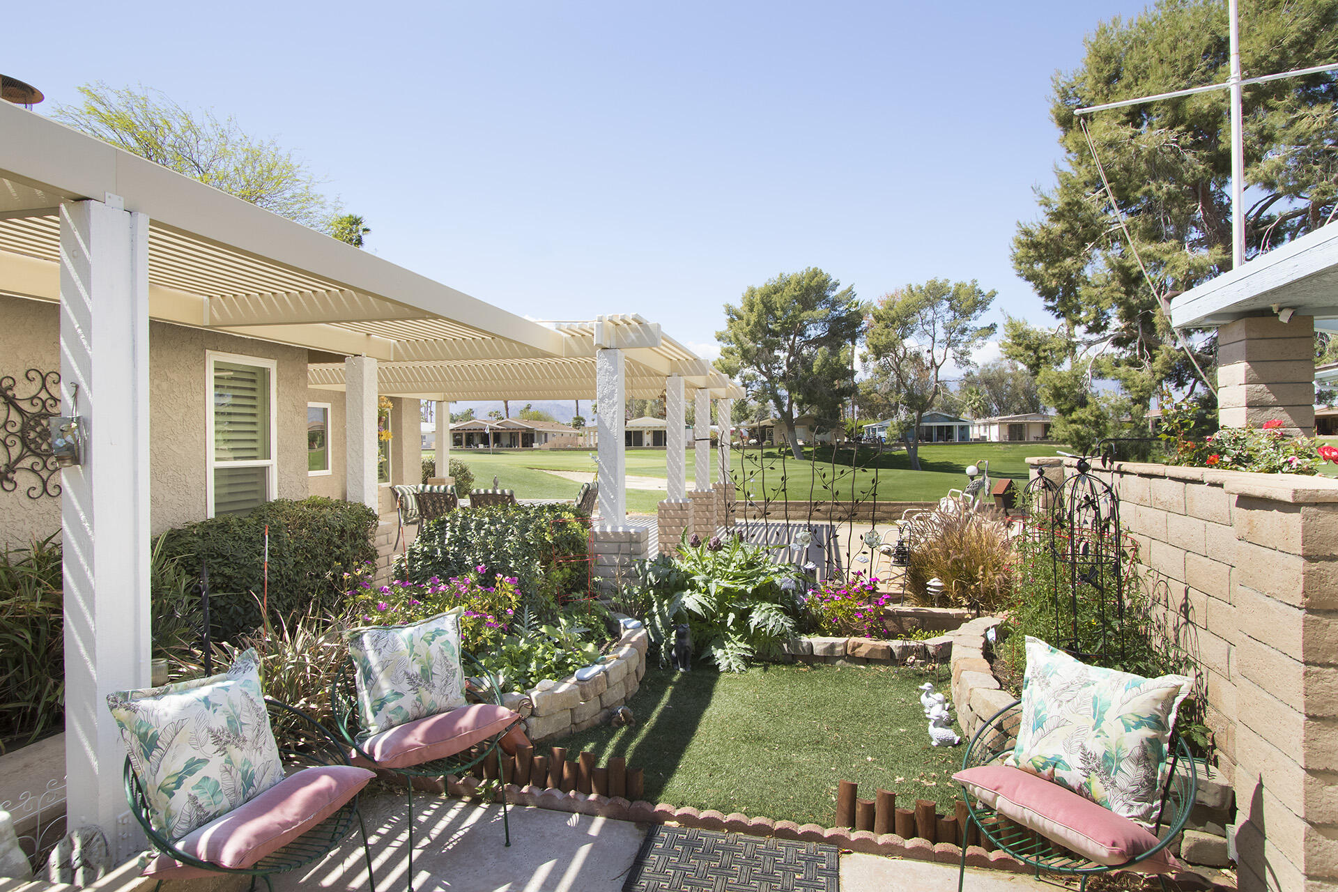 34649 Double Diamond Drive Thousand Palms, CA 92276 - Photo 2 of 42 a view of a patio with couches table and chairs and potted plants