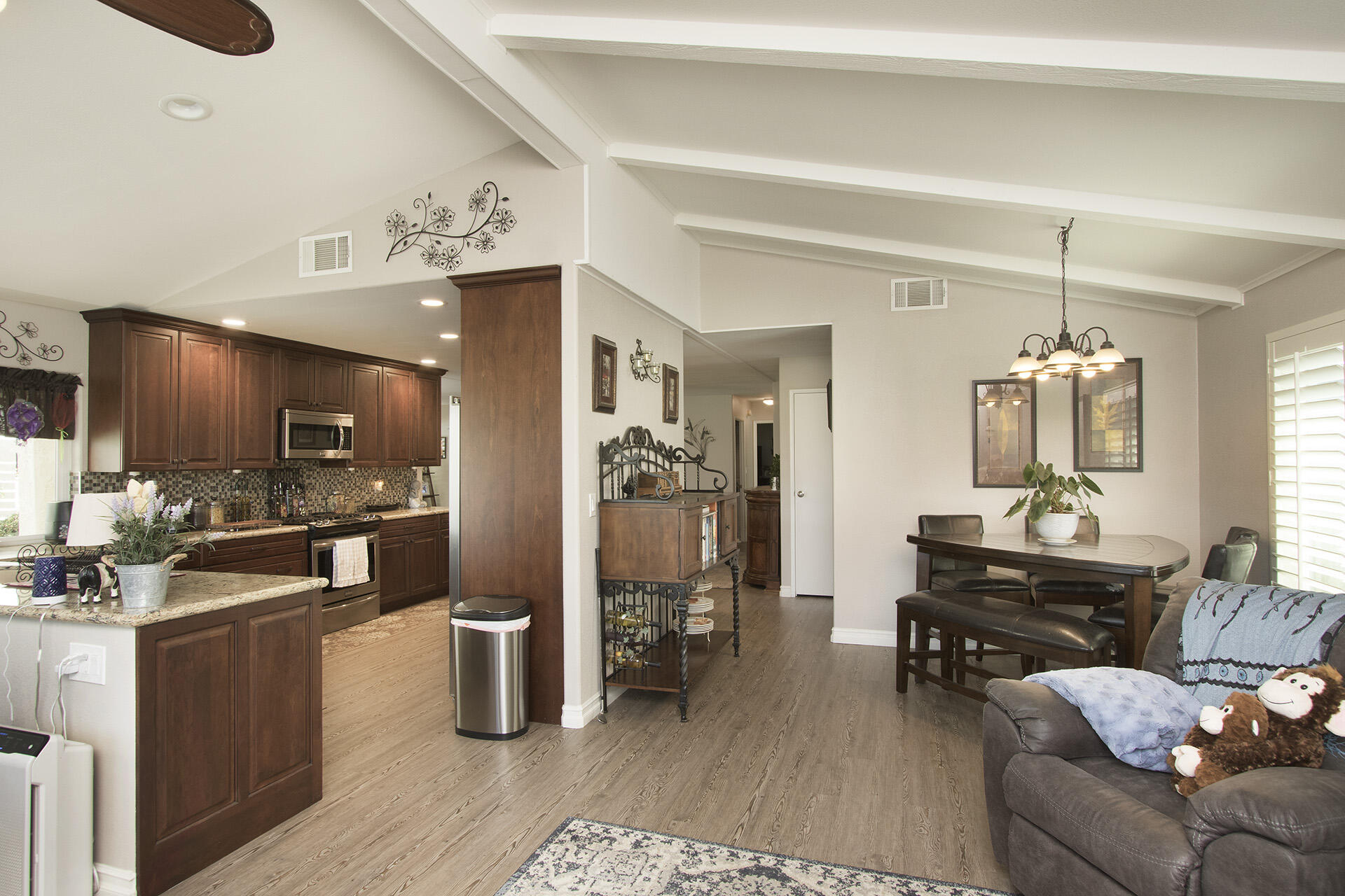 34649 Double Diamond Drive Thousand Palms, CA 92276 - Photo 21 of 42 a living room with furniture a dining table and chairs with wooden floor