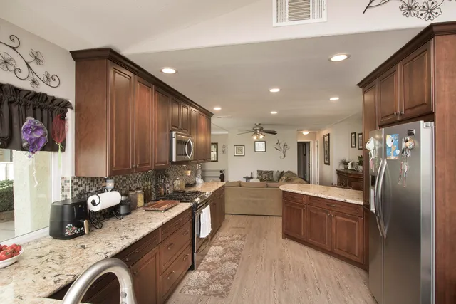 a view of a dining room with furniture and a chandelier