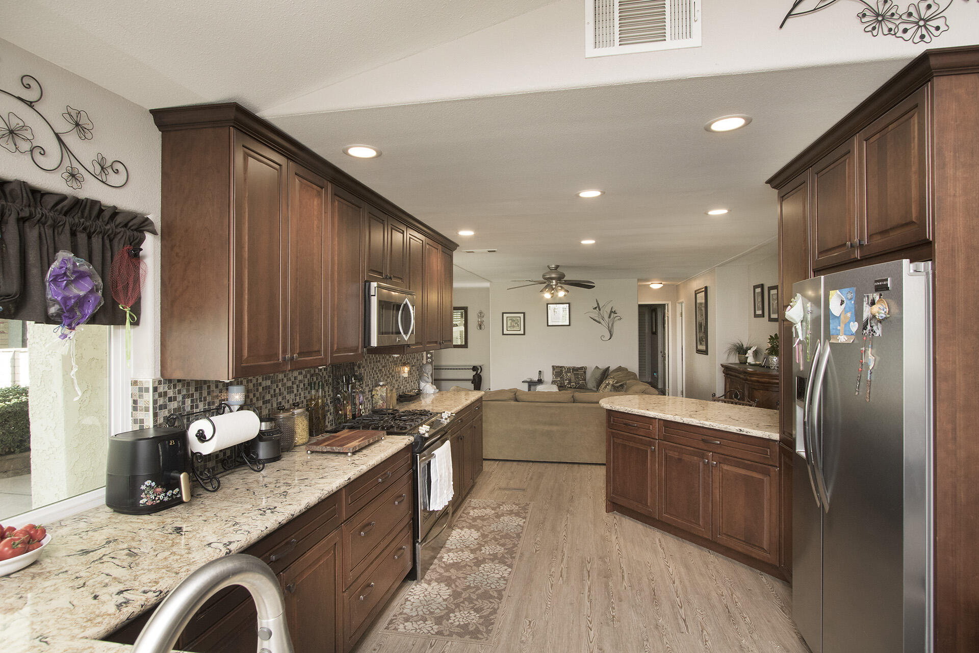34649 Double Diamond Drive Thousand Palms, CA 92276 - Photo 23 of 42 a kitchen with stainless steel appliances granite countertop a sink refrigerator and cabinets