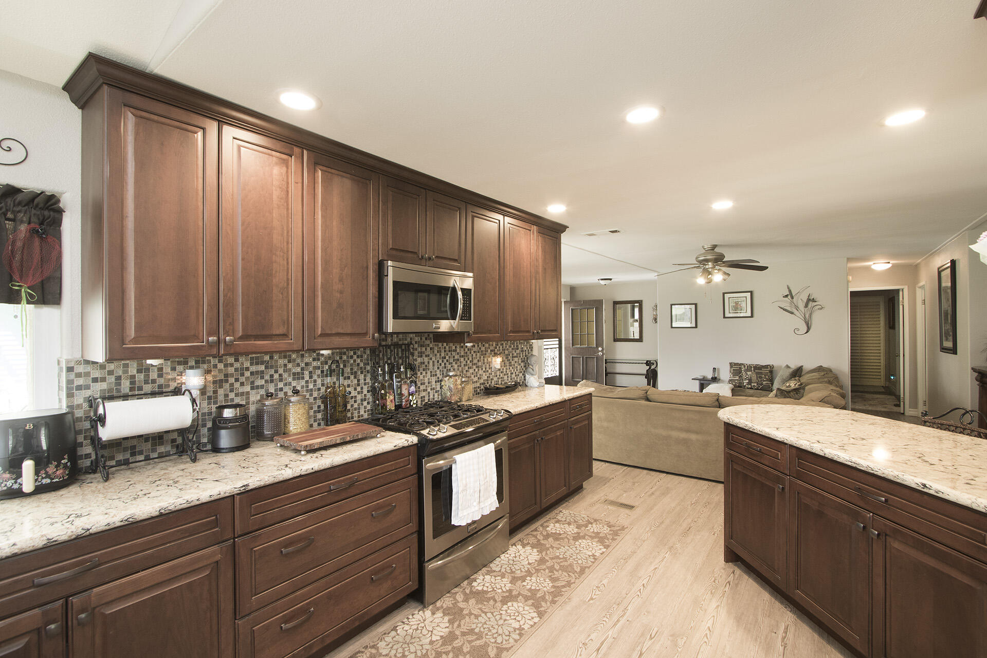 34649 Double Diamond Drive Thousand Palms, CA 92276 - Photo 25 of 42 a large kitchen with stainless steel appliances granite countertop a sink stove and cabinets