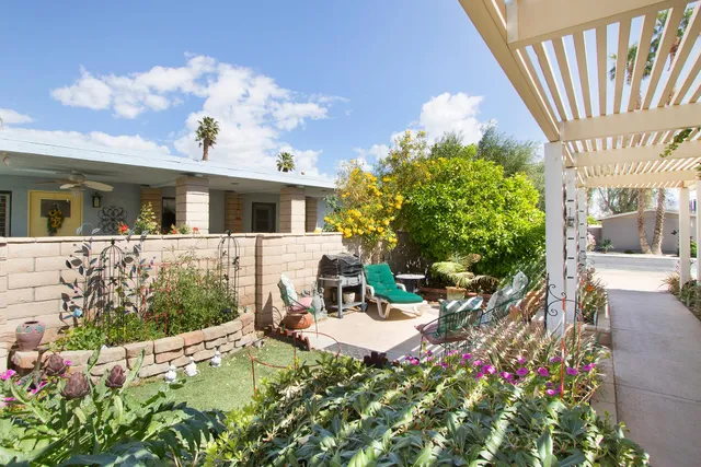 a view of a patio with table and chairs and potted plants