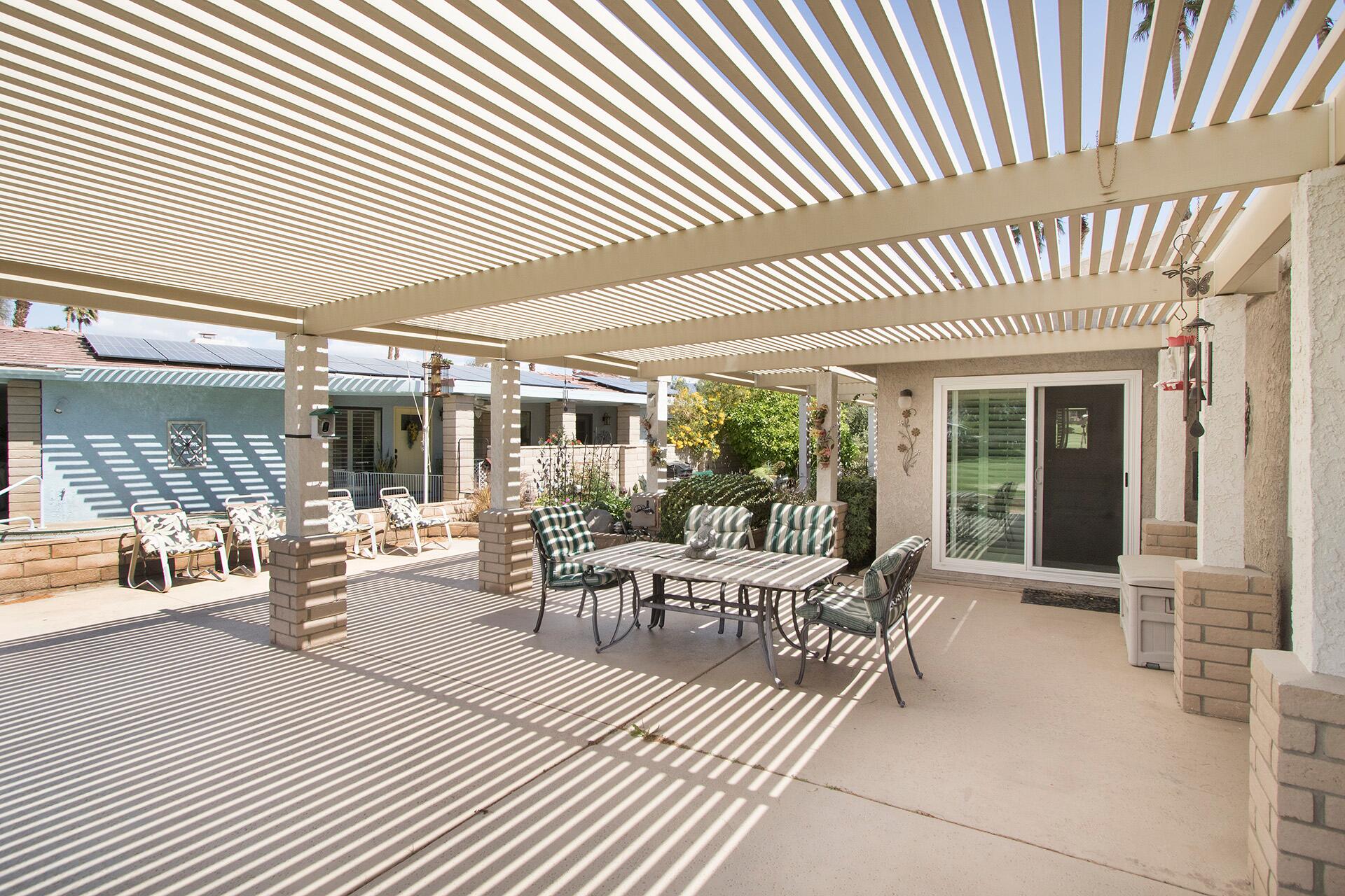 34649 Double Diamond Drive Thousand Palms, CA 92276 - Photo 35 of 42 a view of a patio with table and chairs and potted plants