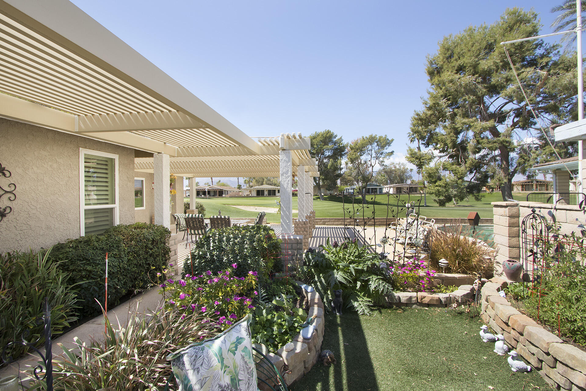34649 Double Diamond Drive Thousand Palms, CA 92276 - Photo 36 of 42 a view of a lake with a house in the background